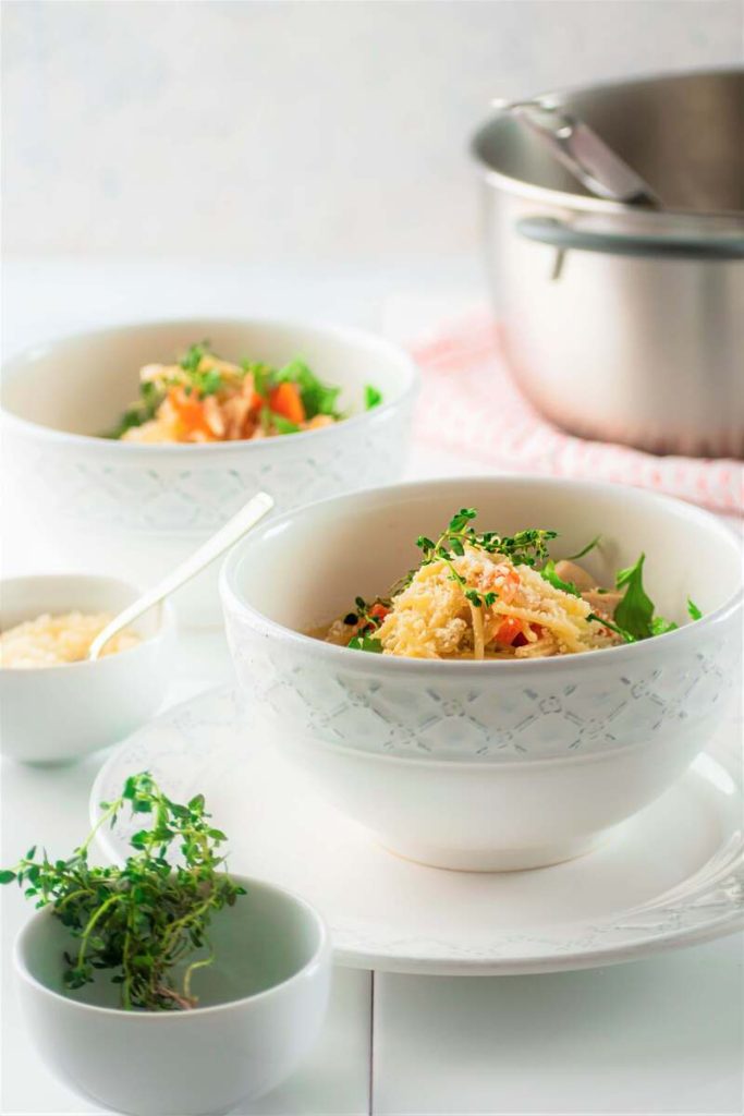 two bowls of soup on a white countertop