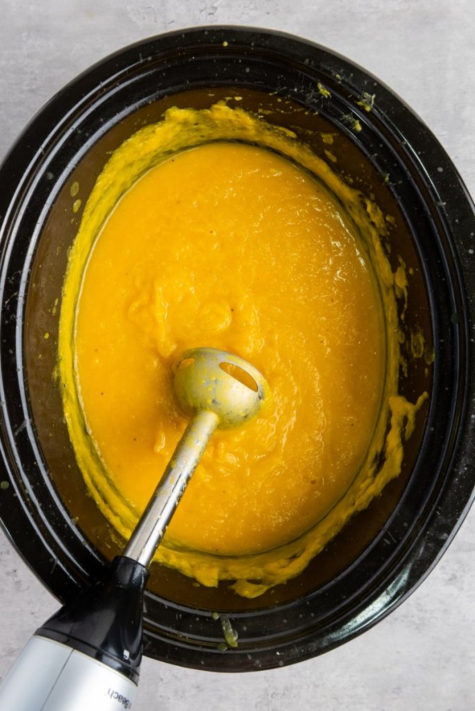 immersion blender in slow cooker bowl after blending