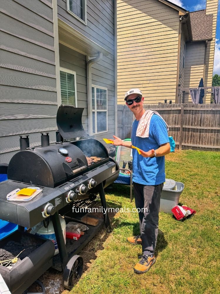 image shows a man at a smoker in his backyard