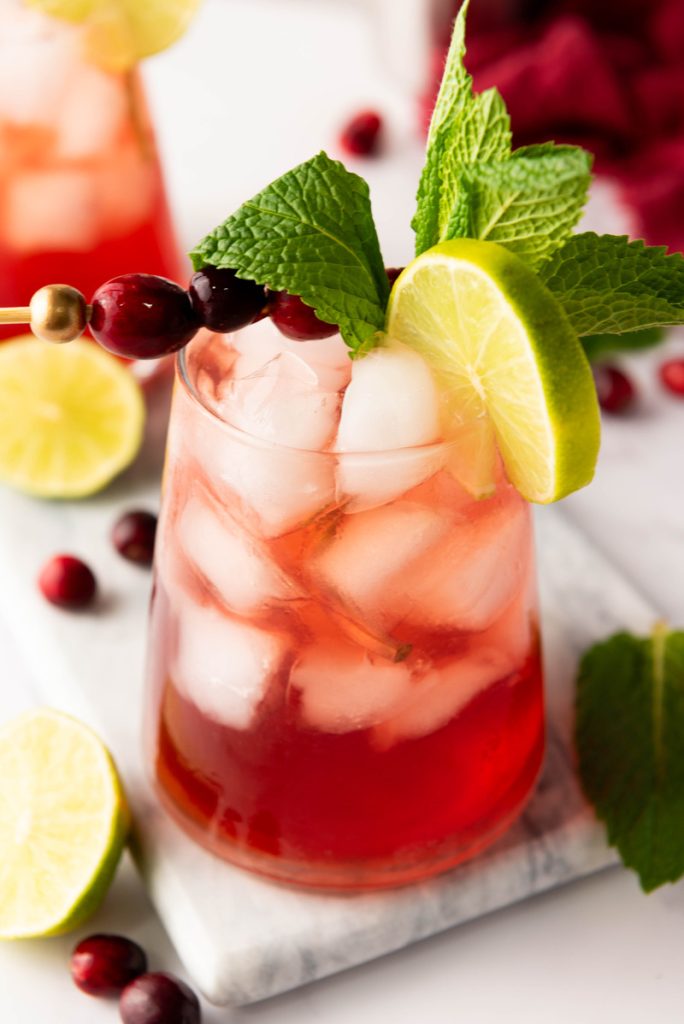 image show a cranberry mocktail with lime and mint