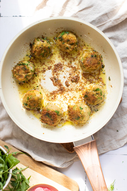 image shows falafel balls being pan fried
