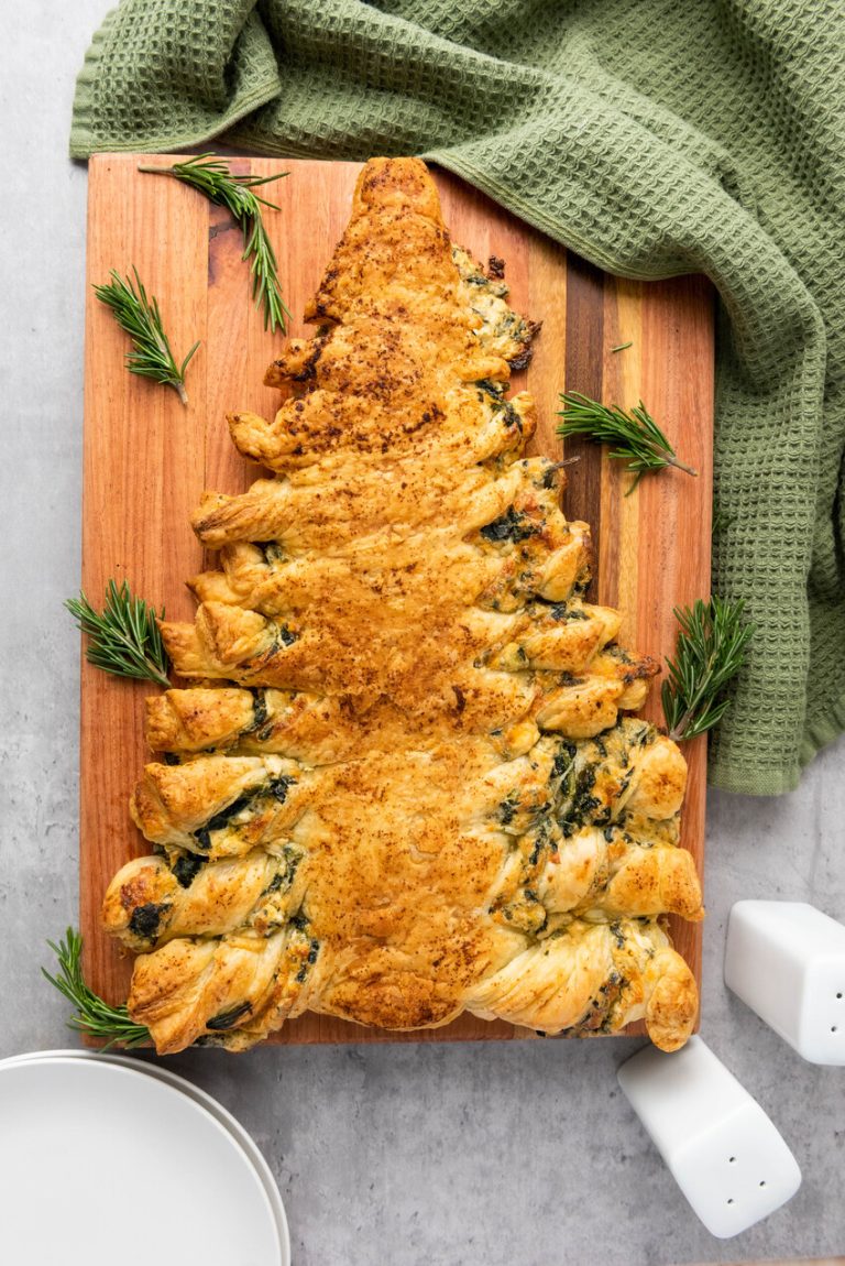 image shows a cooked savory spinach puff pastry appetizer made to look like a Christmas tree