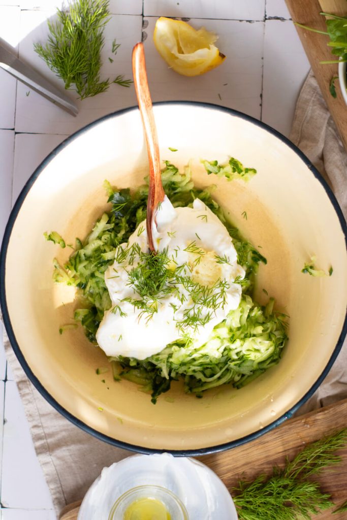 image shows tzatziki sauce ingredients in a bowl
