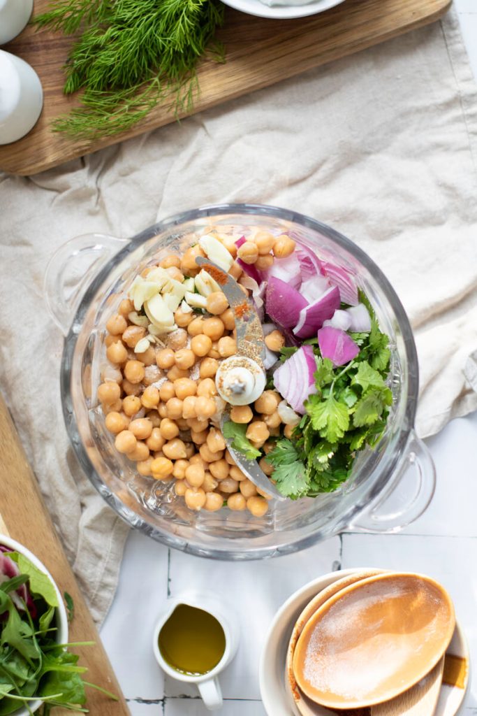 image shows falafel ingredients in food processor