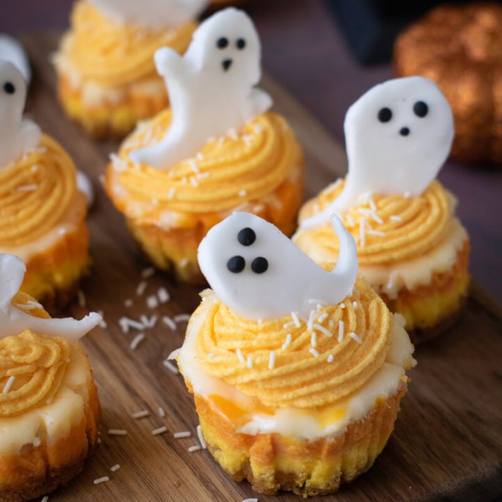 image shows halloween cheesecake cupcakes with ghosts